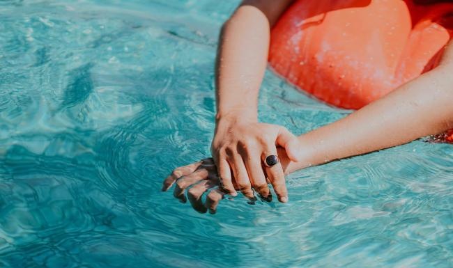 Relax and unwind poolside woman relaxes on a floatie in swimming pool