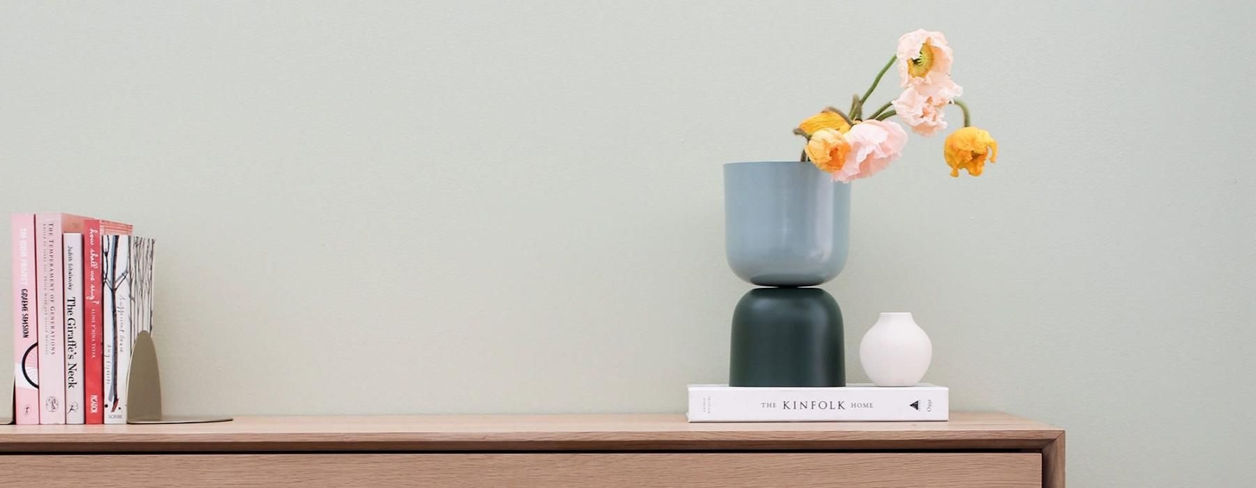 a vase with flowers on a table